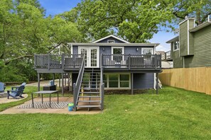 A two-story house with a deck, a ladder, and a covered patio area. - Three Waters Escape | 2 Kings | Game Lounge (Valparaiso)
