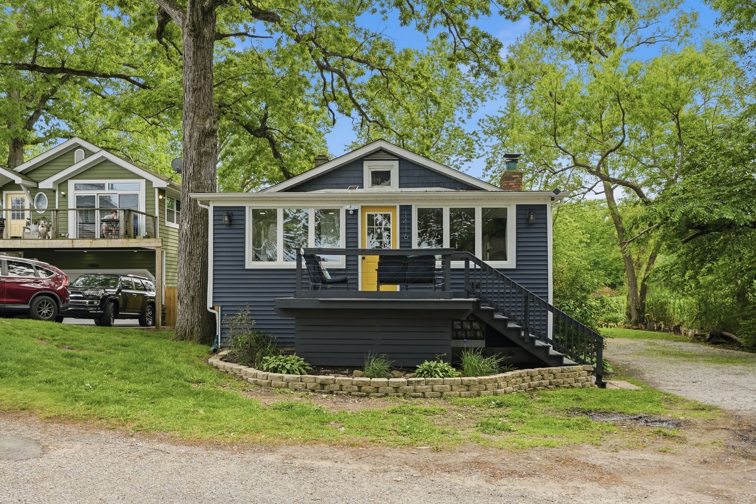 A two-story house with a front porch, a staircase, and a garage.