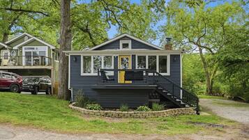 A two-story house with a front porch, a staircase, and a garage.