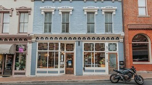A corner building with large windows and a motorcycle parked in front. - Daydream & Draft (Staunton)