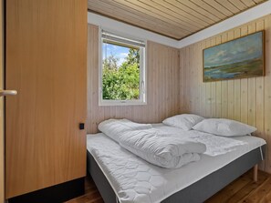 A bedroom with a bed, a window, and a painting on the wall. - "Ursula" - 7km from the sea by Interhome (Ebeltoft)