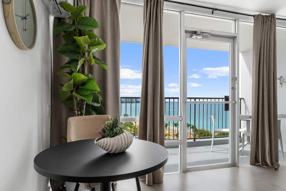 Estudio superior, balcón, vista al océano | Tabla de planchar con plancha, wifi gratis y ropa de cama