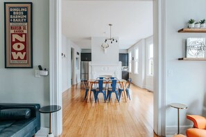 A modern kitchen with a dining area, a fireplace, and a framed poster on the wall. - Hilltop Hideaway (Staunton)