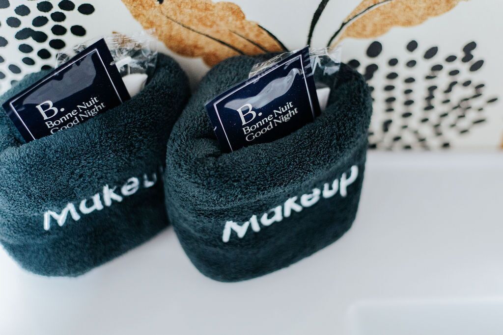 A pair of dark blue slippers with 'Bonne Nuit Good Night' tags and 'Makup' branding.