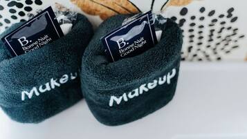 A pair of dark blue slippers with 'Bonne Nuit Good Night' tags and 'Makup' branding.