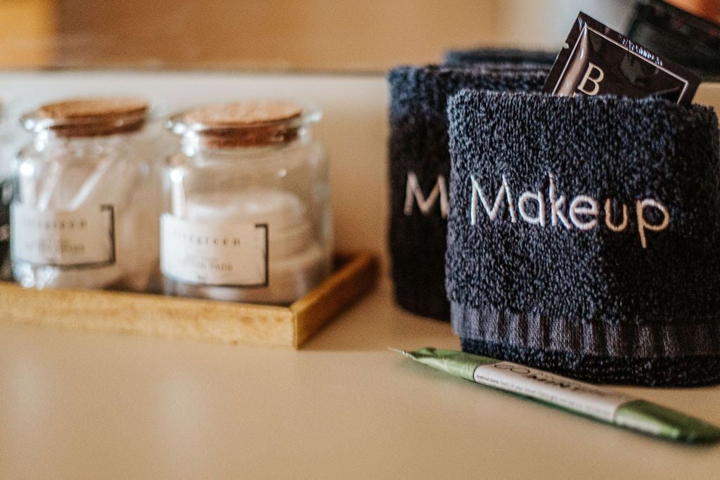 A makeup kit with jars labeled 'M' and 'Makeup' on a countertop.