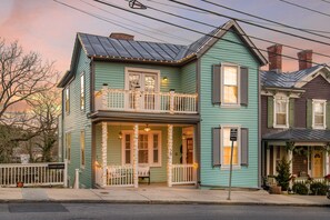 A two-story house with a balcony, a porch, and a visible front door. - The Landmark (Staunton)