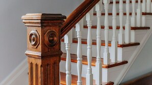 A wooden staircase with white balusters and a wooden handrail. - The Wayne Shire (Waynesboro)