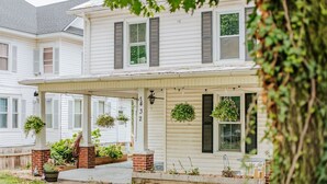 A two-story house with a covered porch, number 1432, and hanging plants. - The Wayne Shire (Waynesboro)
