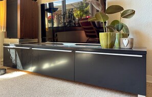 A kitchen with a dark countertop, a sink, and a window reflecting outdoor scenery. - Beautiful home in Haderslev with WiFi (Haderslev)