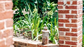 A brick wall with a sign indicating an Airbnb property. - Red Bud Suite (Staunton)