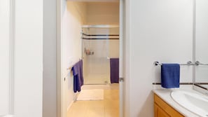 A bathroom with a shower, a sink, and a towel rack. - Waterfront 2BR Condo-Walk to Iconic Seattle Spots (Seattle)
