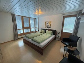 A bedroom with a bed, a desk, and a chair. - Ferienhaus La Trapla, (Samnaun-Compatsch) by Interhome (Samnaun)