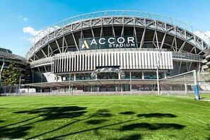 ACCOR Stadium with a large, open field in front.