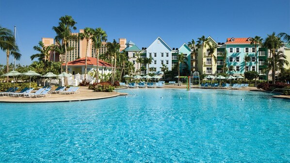 A resort pool with sun loungers and palm trees. - 1-Bedroom/Bath Villa - Marriott Vacation Clubs - Harborside Resort at Atlantis (Paradise Island BS N-4777)