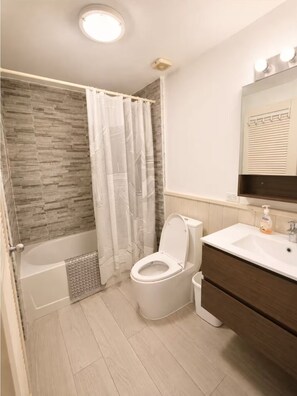 A bathroom with a shower, toilet, vanity, and a mirror. - Rare Villa on Jolly Golf Course w/ Plunge Pool (Jolly Harbour)