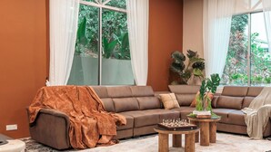 A living room with a brown sofa, a coffee table, and a rug.
