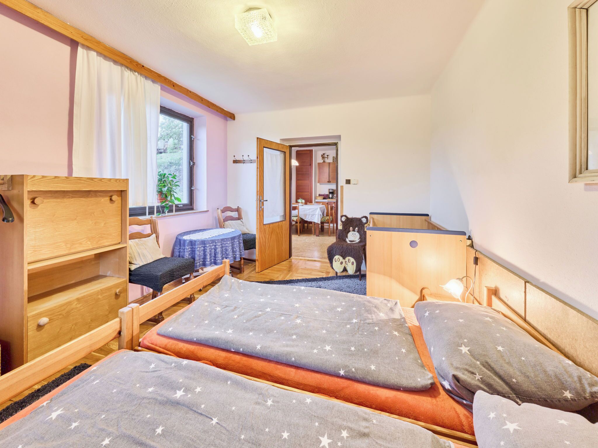 A cozy room with a bunk bed, a desk, and a chair.