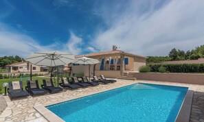 A swimming pool with lounge chairs and umbrellas, a stone pathway, and a building with a tiled roof. - Villa Talora Nearby Labin - Crovillas (Sveta Nedelja)