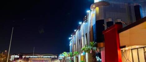 A hotel named 'LAVERA Hotel' with a modern architectural design, featuring a prominent sign and a well-lit facade.