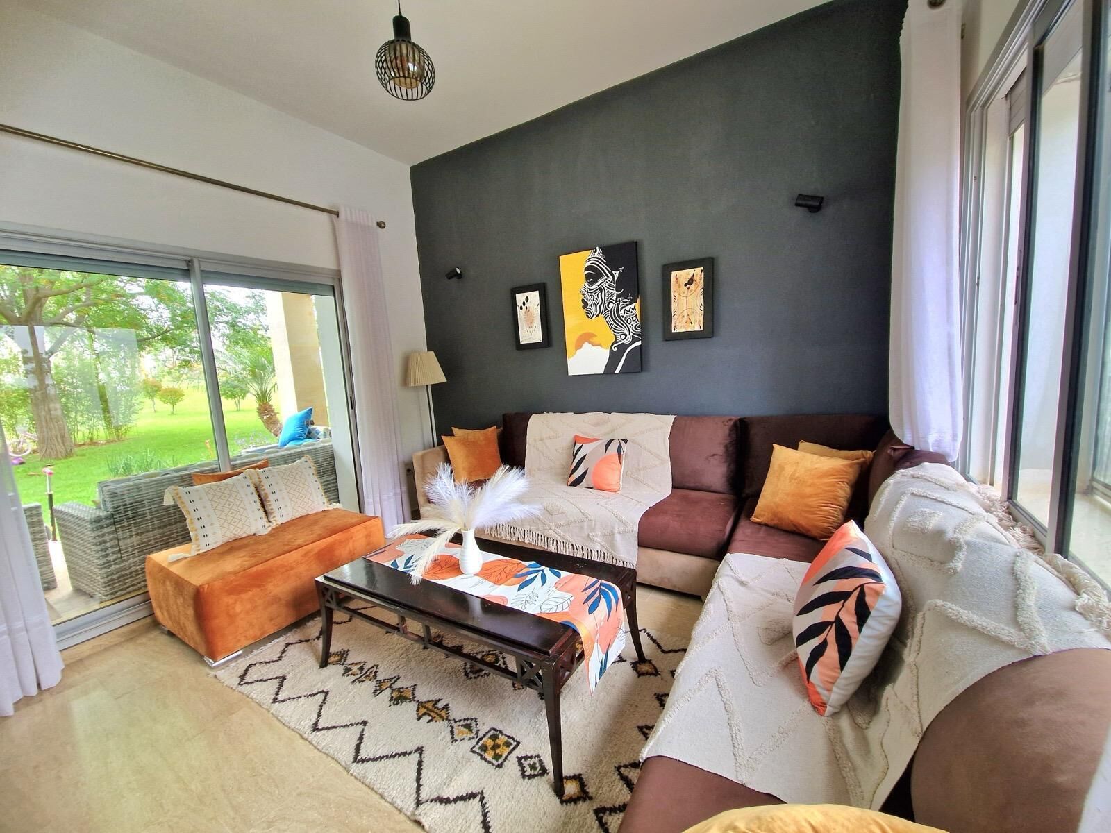 A modern living room with a sofa set, a coffee table, and artwork on the wall.