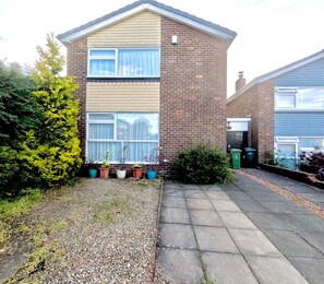 A two-story brick house with a front garden, a driveway, and a neighboring house. - House Sleeps 5 With Enclosed Garden (Newcastle-upon-Tyne)