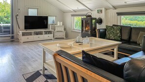 A living room with a television, fireplace, sofa, and a dining table. - Stunning home in Toftlund with WiFi (Toftlund)