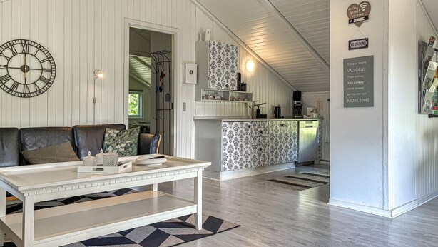 A modern kitchen with white cabinetry, a black and white patterned backsplash, and a built-in dishwasher. - Stunning home in Toftlund with WiFi (Toftlund)