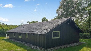 A wooden cabin with a sloped roof, surrounded by a gravel path and lush greenery. - Stunning home in Toftlund with WiFi (Toftlund)