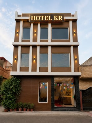 A modern hotel building with a sign reading 'HOTEL KR'.