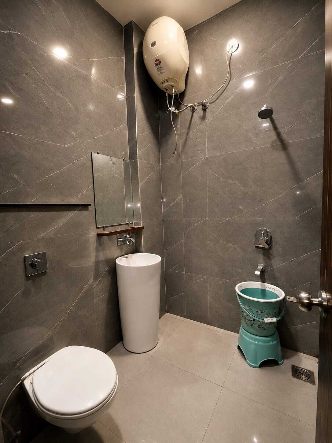 A modern bathroom with a toilet, sink, and shower.