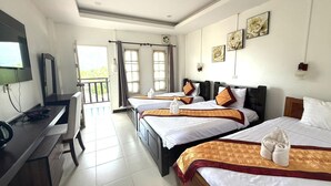 A hotel room with two beds, a desk, a TV, and a balcony. - Cozy Corner Hotel (Vang Vieng)