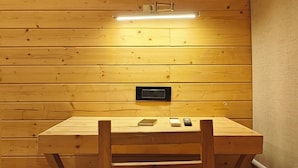 A room with a wooden desk, chair, and a ceiling light fixture. - Karibu Resort Karjat (Karjat)