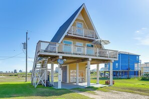 A two-story house with a balcony, a garage, and a satellite dish. - Walk to Waves! Surfside Beach House w/ Ocean View (Surfside Beach)