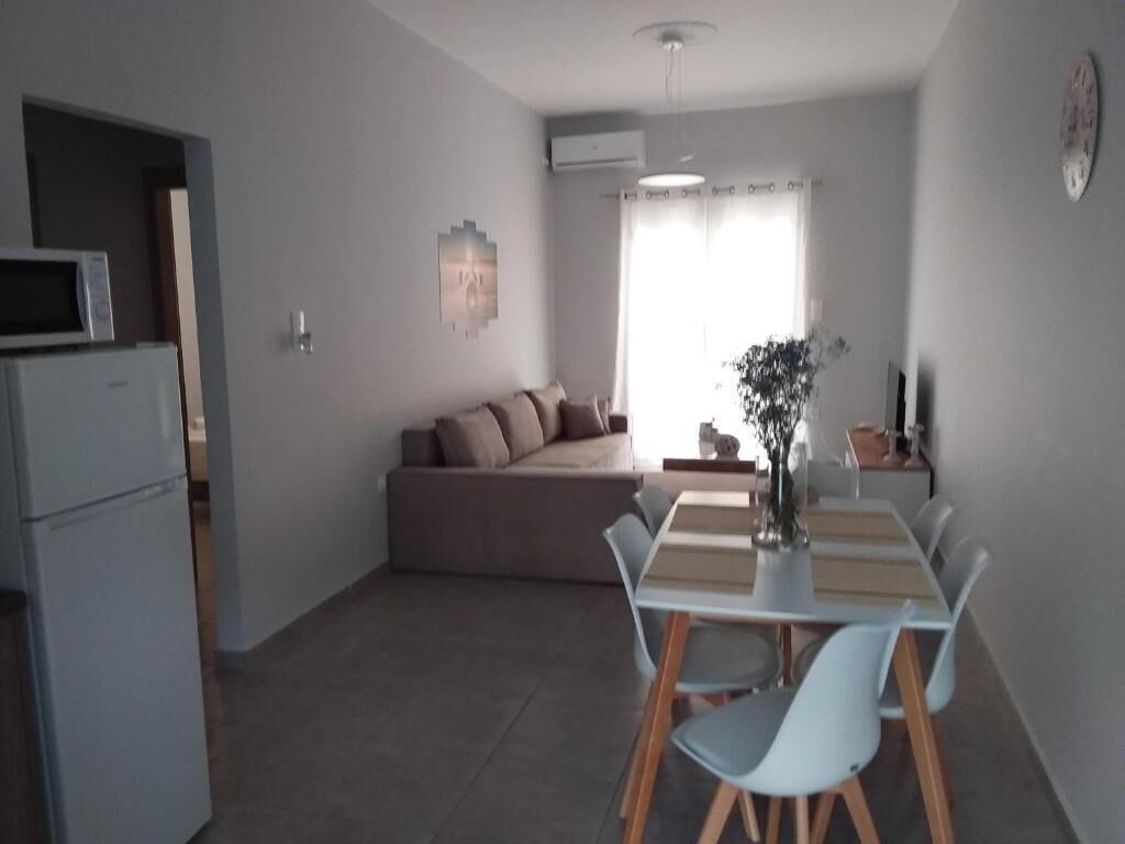 A compact living space with a kitchenette, a dining area, and a seating area.