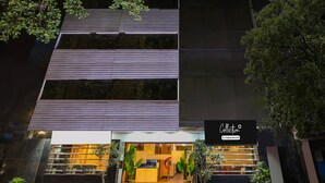 A modern building with horizontal windows and a sign reading 'Collection Company-Serviced'. - Deluxe Collection O Park Circus (Kolkata)