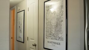 A hallway with framed maps of Scottsdale, Arizona, and a door with a doorbell. - 4-bdrm home with 2 Master Suites & Heated Pool minutes from Old Town Scottsdale (Scottsdale)