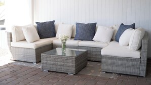 A sectional sofa with a glass coffee table and a vase of flowers. - 4-bdrm home with 2 Master Suites & Heated Pool minutes from Old Town Scottsdale (Scottsdale)