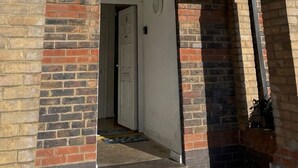 A brick building with a door leading to an interior hallway. - Modern London Stay for 5|Parking| Excel, City Airport & Canary Wharf (London)