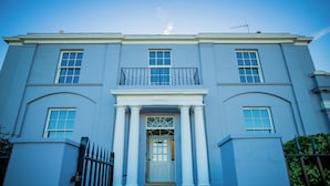 A large, stately building with a symmetrical facade, a central entrance with columns, and a balcony above the door. - Bankhouse Troon, Scotland | Luxury Sea View Retreat with Hot Tub & Sauna (Troon)