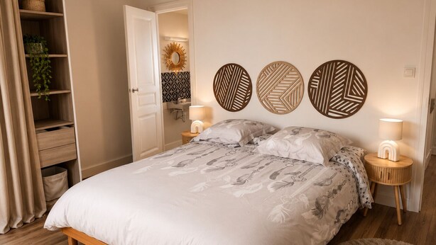 A bedroom with a wooden bed, two bedside tables with lamps, a wall-mounted mirror, and a shelf with a plant. - Entre Rails & Rives (Montbard)