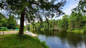 A riverside park with a wooden dock, benches, and lush greenery. - Rustic River Front Cottage Cozy*Kayaks*Hot Tub*Games (Kawartha Lakes)
