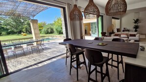 A modern dining area with a large table, chairs, and hanging wicker lamps. - Charming winegrower's farmhouse/villa recently renovated with swimming pool max 14 pers. (Marsillargues)