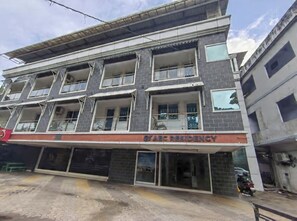 A multi-story building with balconies and a sign reading 'ABC RESIDENCY'.