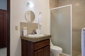 A bathroom with a sink, mirror, towel rack, and toilet.
