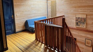 A wooden interior with a staircase, a door, and a skylight. - Chalet in the Les Rousses resort, between Prémanon and LAMOURA (PREMANON)