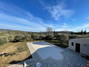 A courtyard with a stone floor, a pergola, and a view of the surrounding landscape. - Large villa with pool in Salernes / Var (Salernes)