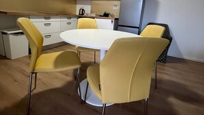 A modern kitchen with a white countertop, a refrigerator, and a sink. - ROSE VALLEY (Ljubljana)