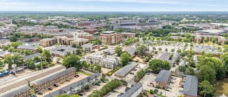 An aerial view of a campus with multiple buildings, parking areas, and green spaces.