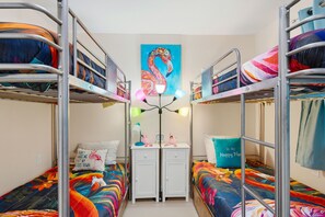 A dormitory room with bunk beds, a desk, and a nightstand. - 3bd golf cart, pool, close to beach (Indian Rocks Beach)